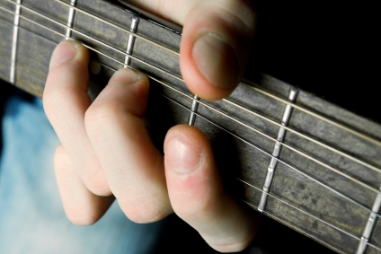 boy learning guitar chords